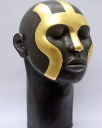 Unglazed raku fired male head, black with gold leaf tribal design