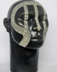 Male ceramic head with tribal design, black, with design in white crackle glaze