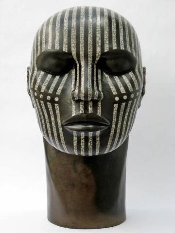 Raku fired ceramic tribal head, black, with white crackled thin lines and dots