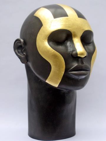Unglazed raku fired male head, black with gold leaf tribal design
