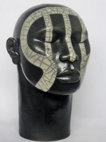 Male ceramic head with tribal design, black, with design in white crackle glaze